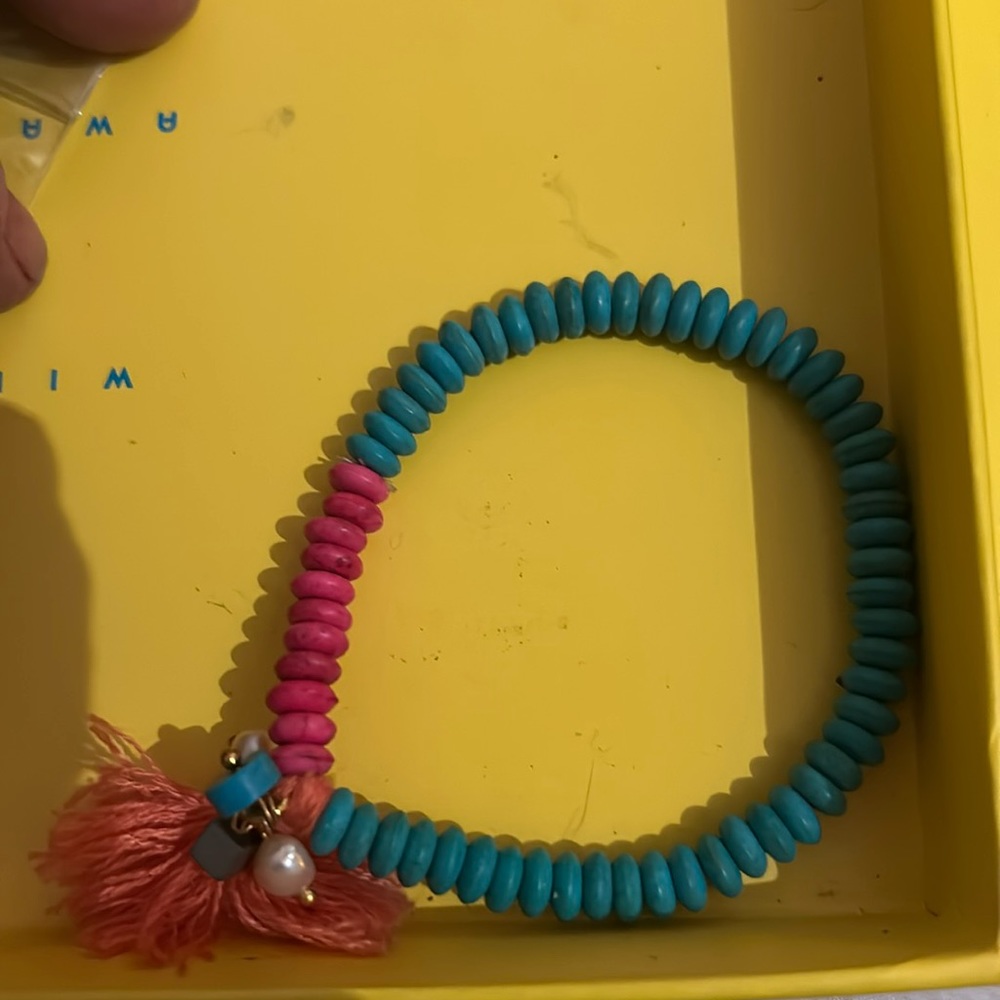 Orange cloth dangle with pink and blue beaded bracelet